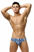 Marcuse Phraya brief swimwear in blue and white patterned fabric with a silver logo on the waistband
