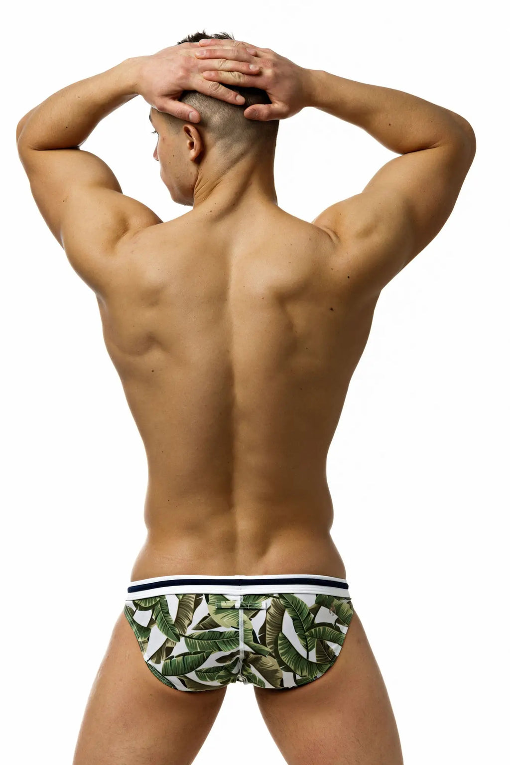 Marcuse Phraya Tanner bikini swimwear with green and white tropical leaf-patterned swim trunks and navy blue striped waistband