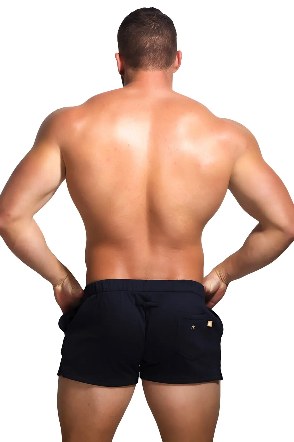 Back view of black Marcuse Physical shorts with drawstring waistband and gold brand logos on back pockets