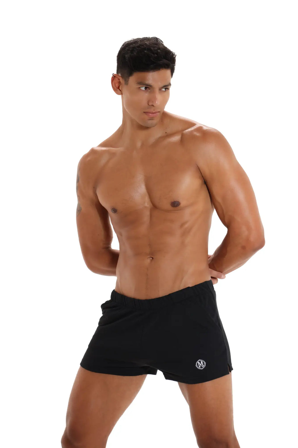 Black marcuse physical shorts with a small white logo on the lower left leg designed for athletic use