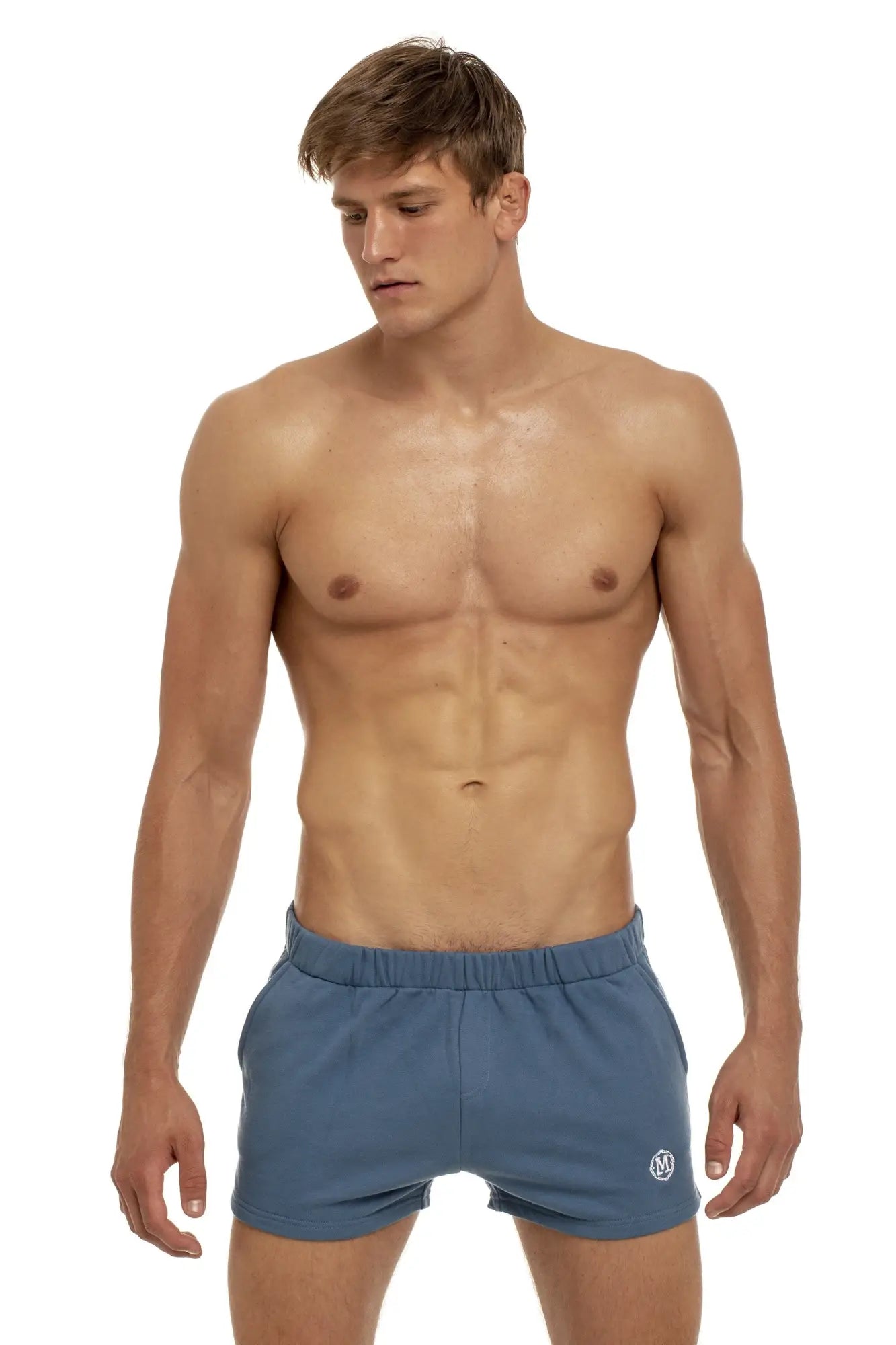 Marcuse physical shorts in blue with elastic waistband and small white logo on the lower right leg