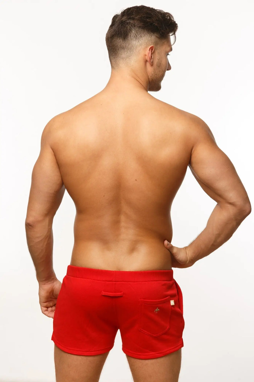 Red marcuse physical shorts with elastic waistband and side pockets designed for athletic use