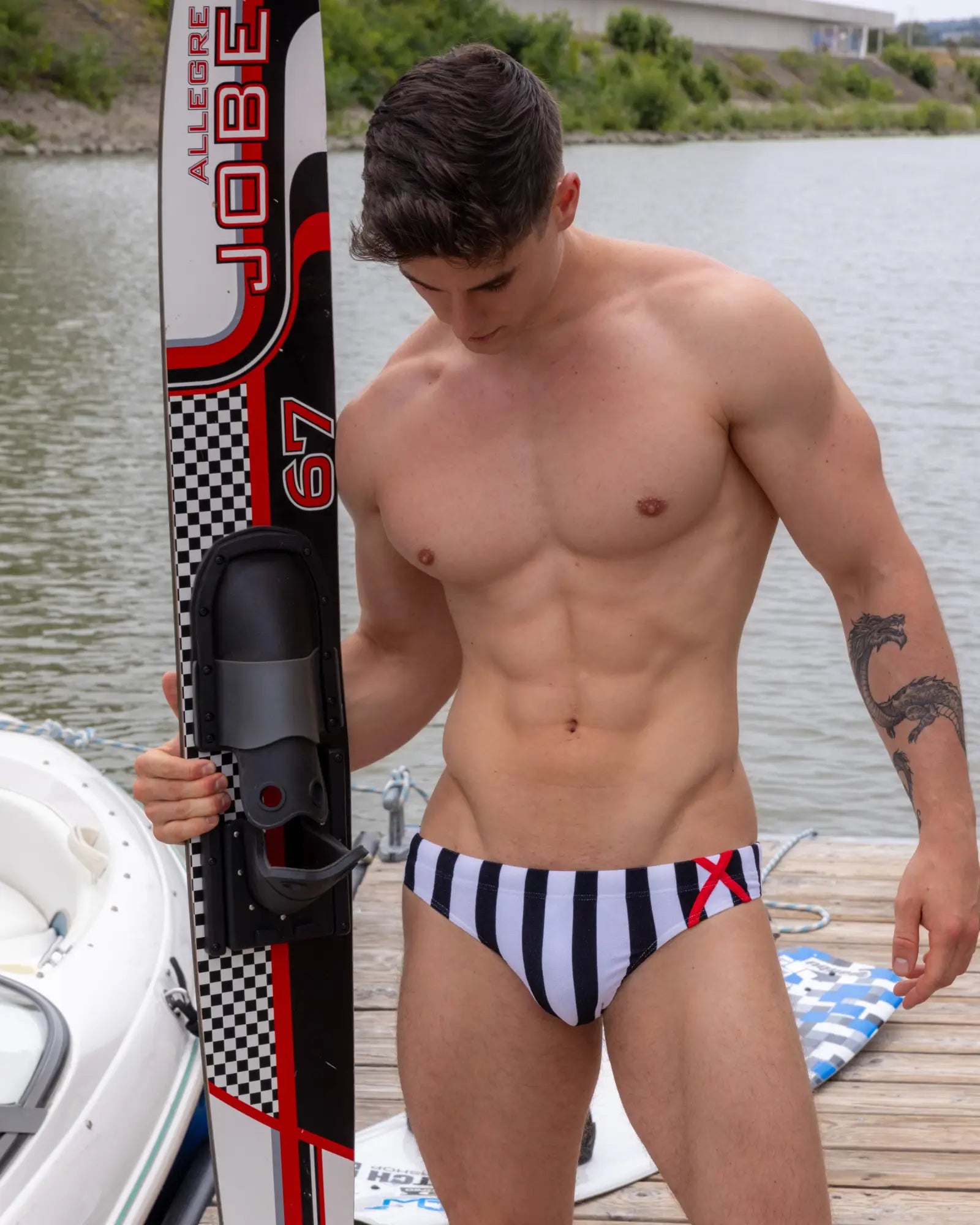 Marcuse promenade bikini swimwear black and white striped swim trunks with red x logo on the side