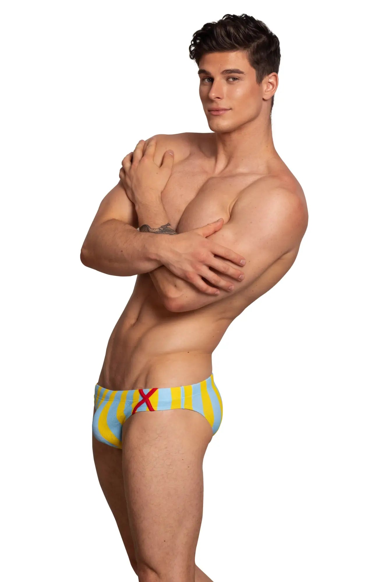 Marcuse promenade bikini swimwear featuring vibrant blue and yellow striped swim trunks with a bold red x design