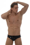 Black Marcuse Proud bikini swimwear trunks with gold drawstrings and white logo on left hip for swimming