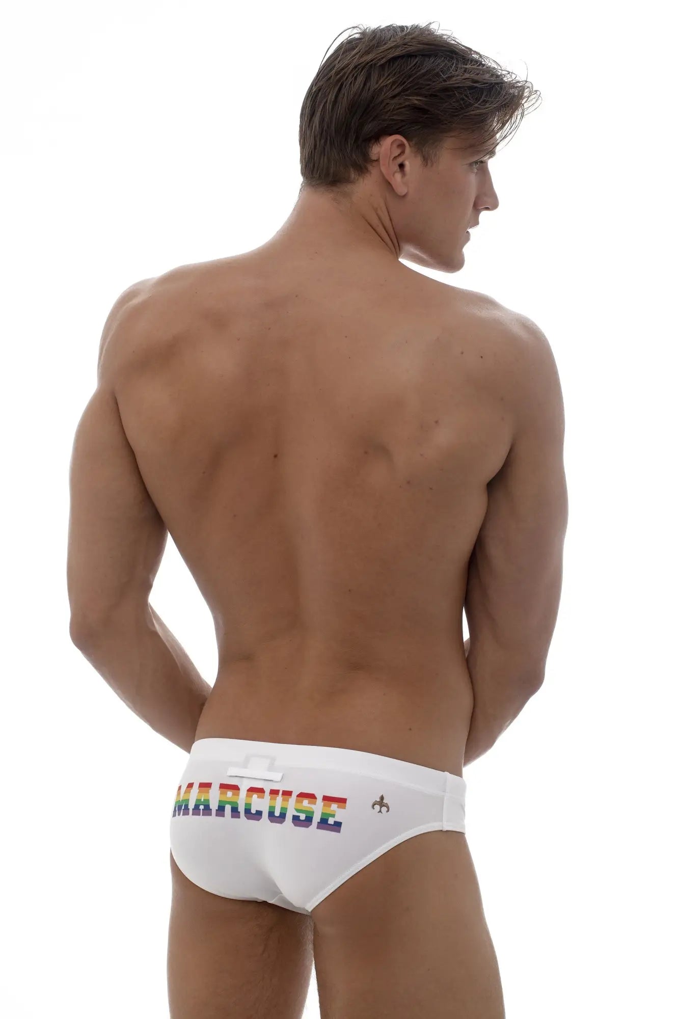 White marcuse swim trunks with rainbow logo on waistband showcasing marcuse proud bikini swimwear design