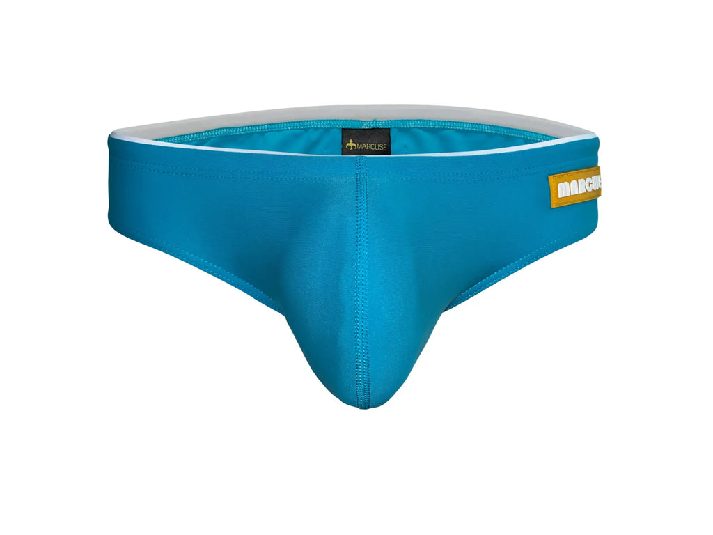 Bright blue form-fitting Marcuse Sandboy bikini swimwear trunks with white lining and yellow brand tag