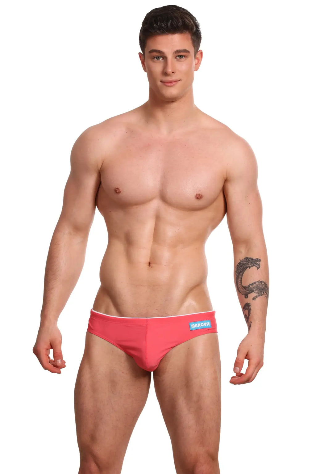 Bright pink Marcuse Sandboy bikini swimwear briefs with white trim and blue brand label on waistband
