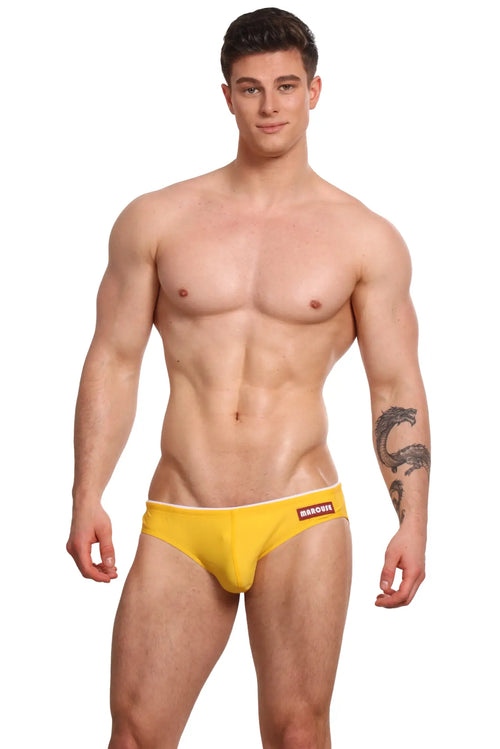 Bright yellow snug-fitting marcuse sandboy bikini swimwear briefs with white trim and babous logo waistband