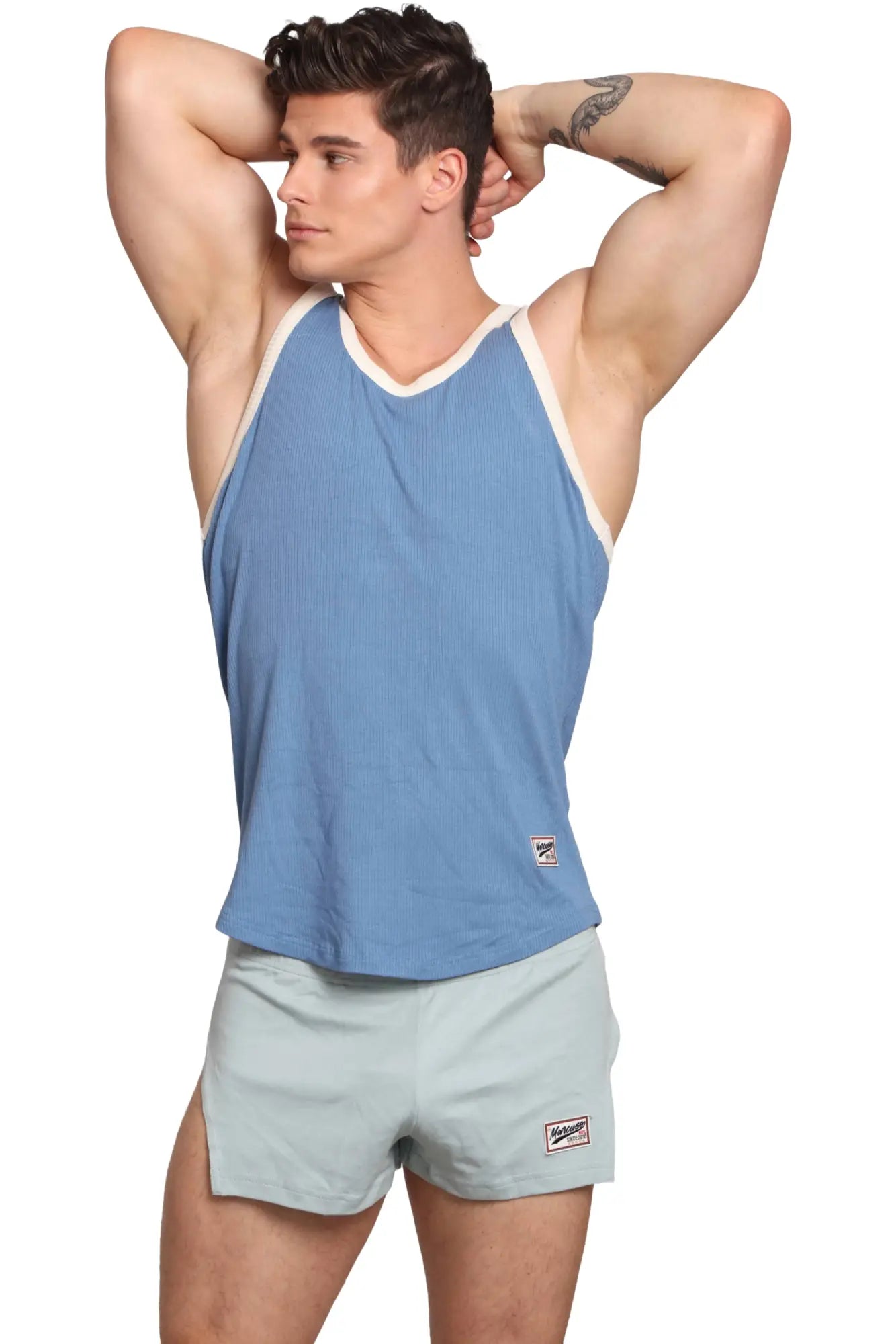 Marcuse Sexercise tank top light blue ribbed fabric with white trim and small brand patch on lower left side
