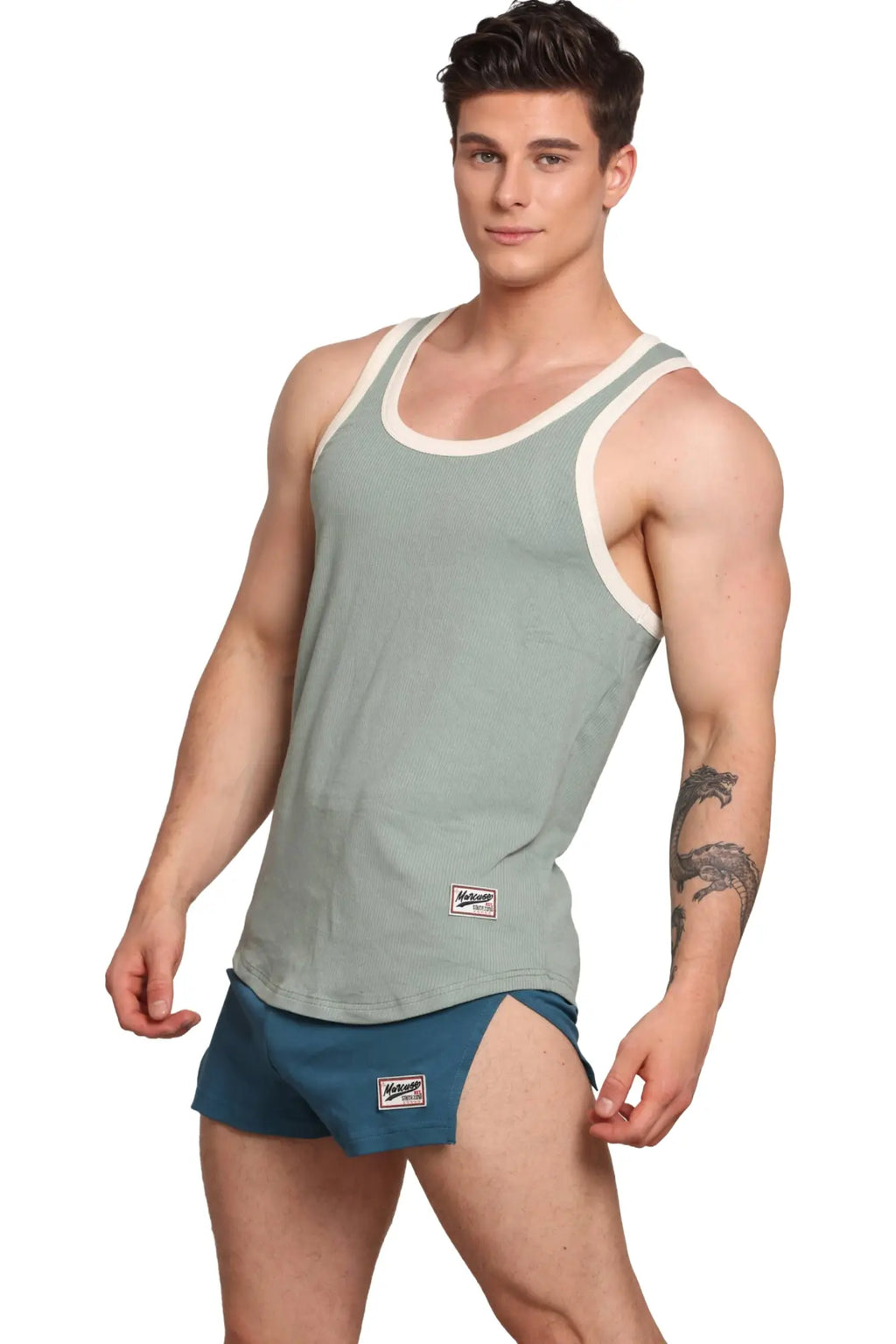Marcuse Sexercise tank top in light green ribbed fabric with white trim and a small brand patch on the front lower side