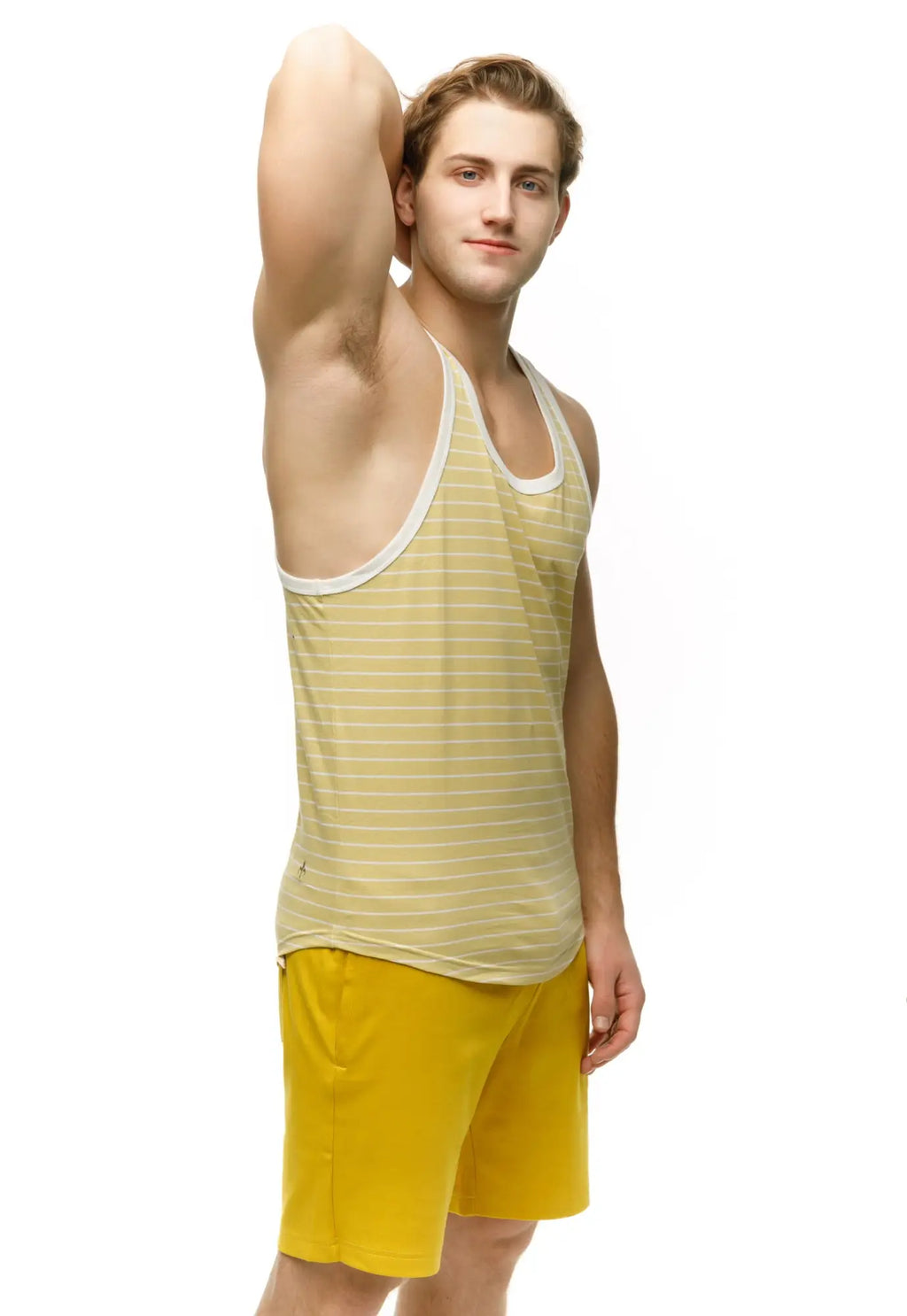 A man wearing a marcuse Somer tank top in yellow and white stripes with white trim showing the front side