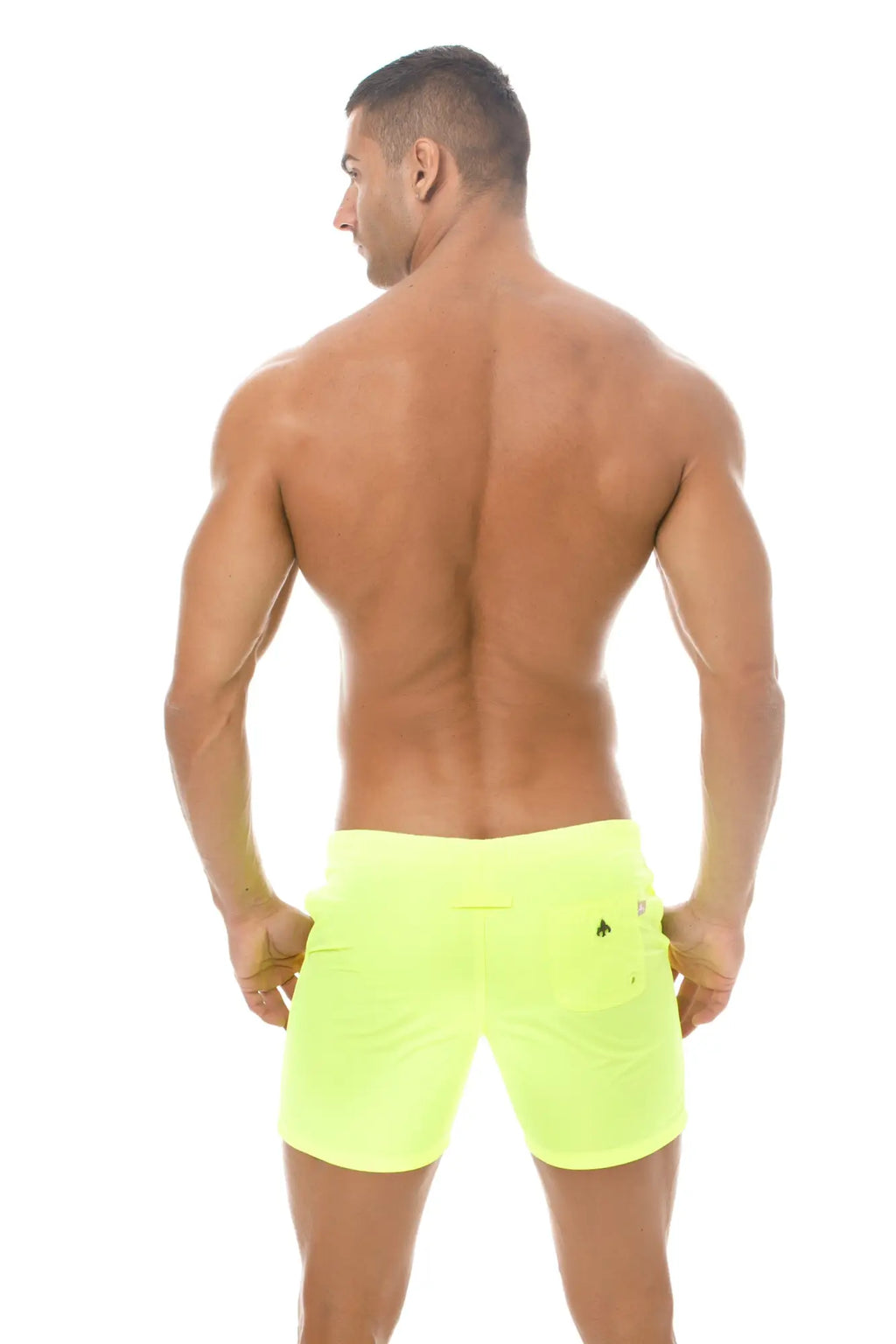 Back view of marcuse spectrum shorts neon yellow athletic shorts with a small black logo on the right pocket