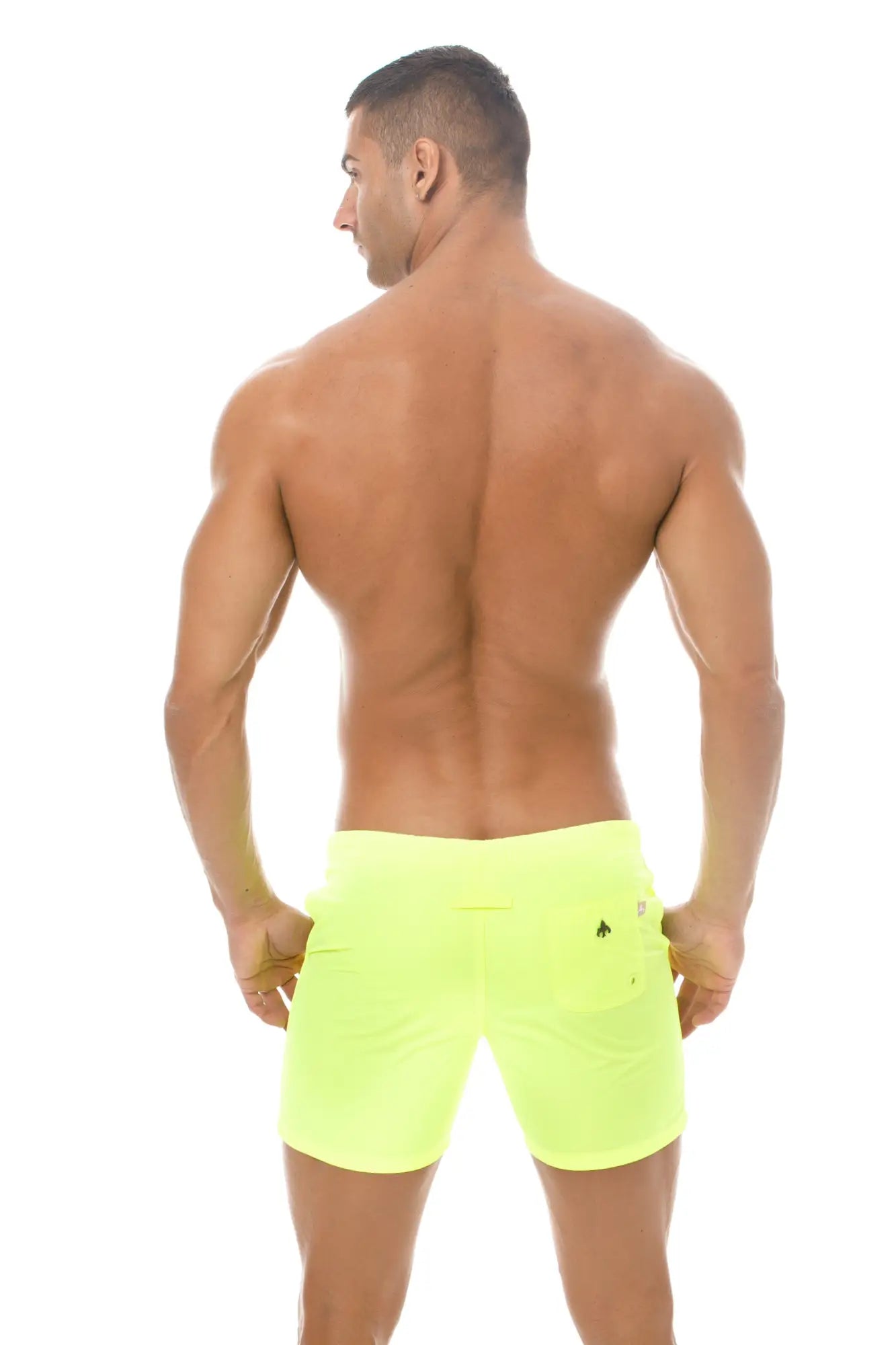 Back view of marcuse spectrum shorts neon yellow athletic shorts with a small black logo on the right pocket