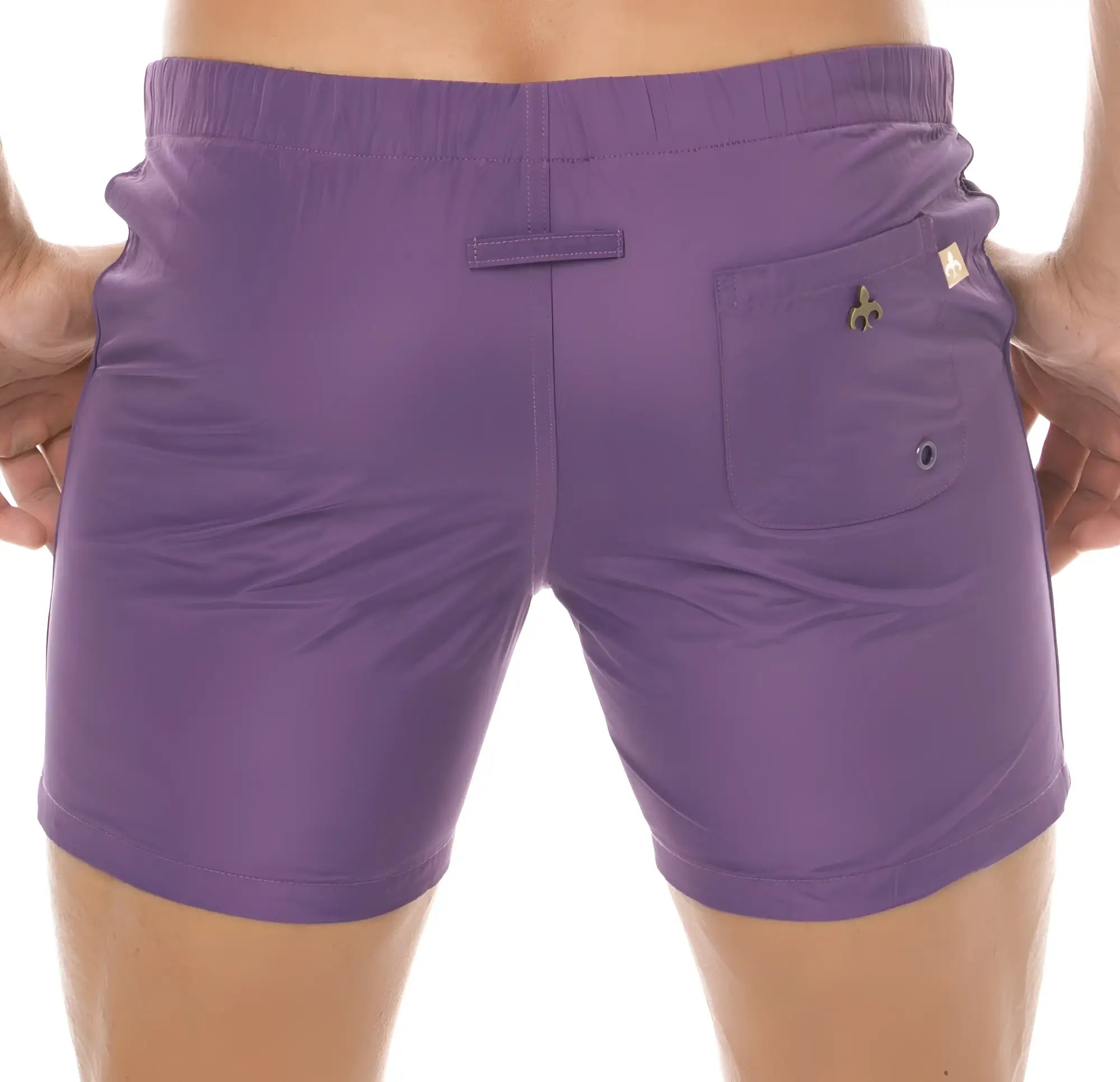 Back side of purple marcuse spectrum athletic shorts with elastic waistband and clover clasp pocket detail