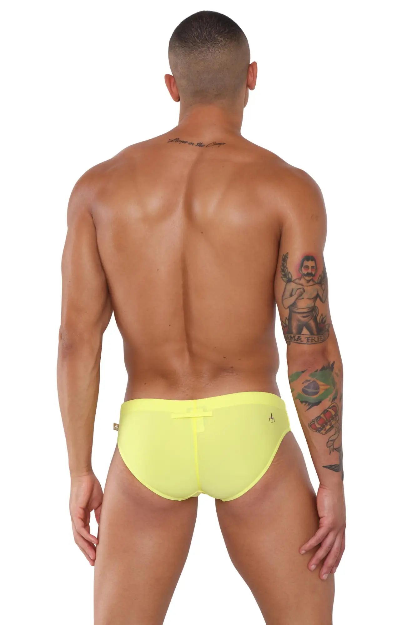Bright yellow marcuse summery bikini swimwear swim trunks with a small logo on the side for summer beach use