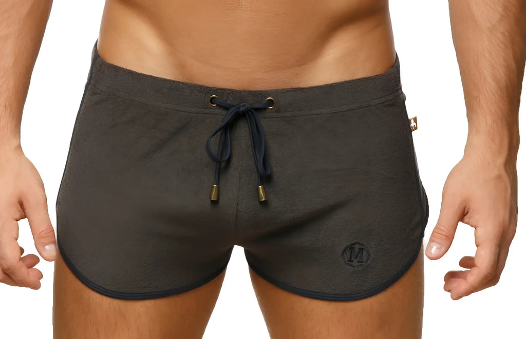 Marcuse sweat shorts in dark gray athletic fabric with navy blue drawstring trim and subtle logo on the lower left leg