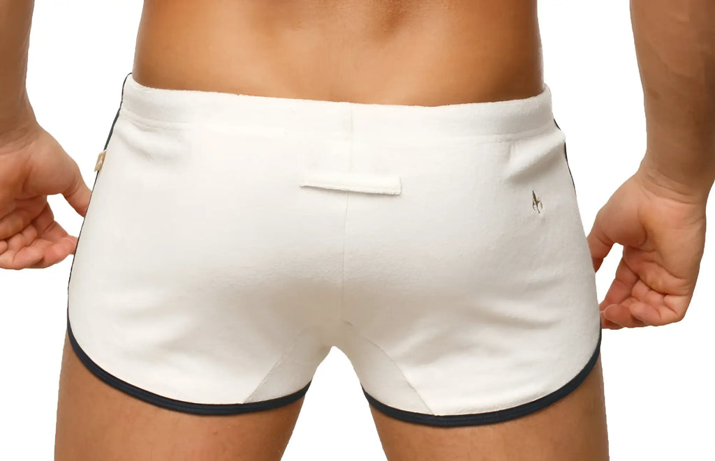 Back view of marcuse sweat shorts in white with navy blue trim and a small logo on the back