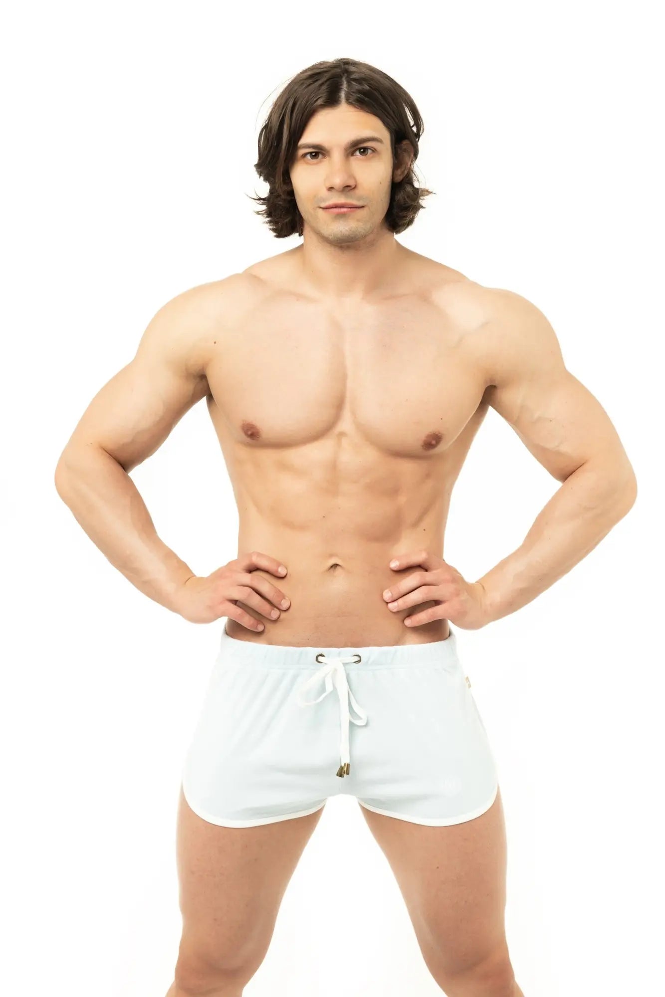 White Marcuse sweat shorts with a drawstring waistband and small metallic accent for athletic wear