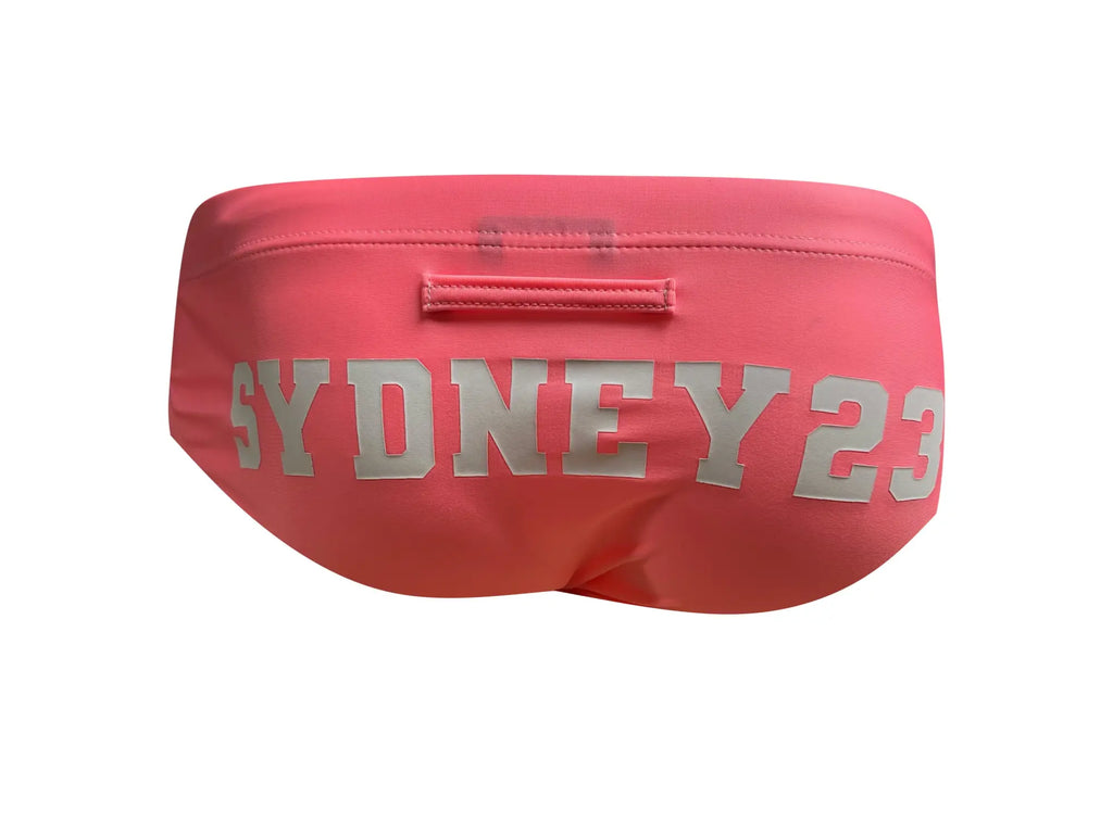 Pink marcuse syd23 bikini swimwear with silver sydney 23 lettering across the front of swim trunks