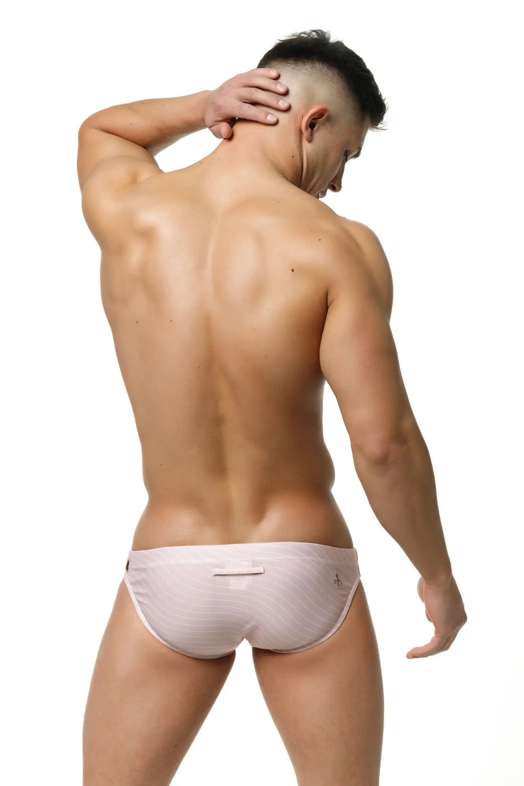 Back view of marcuse tasman bikini swimwear light pink textured briefs with a small logo on the back