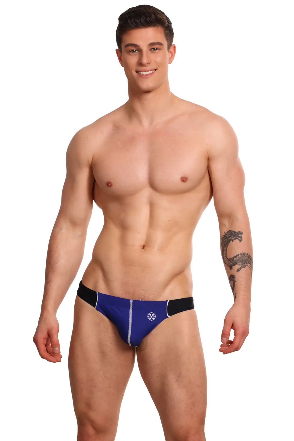 Marcuse Tropez bikini swimwear featuring blue and black swim trunks with a white logo on the front