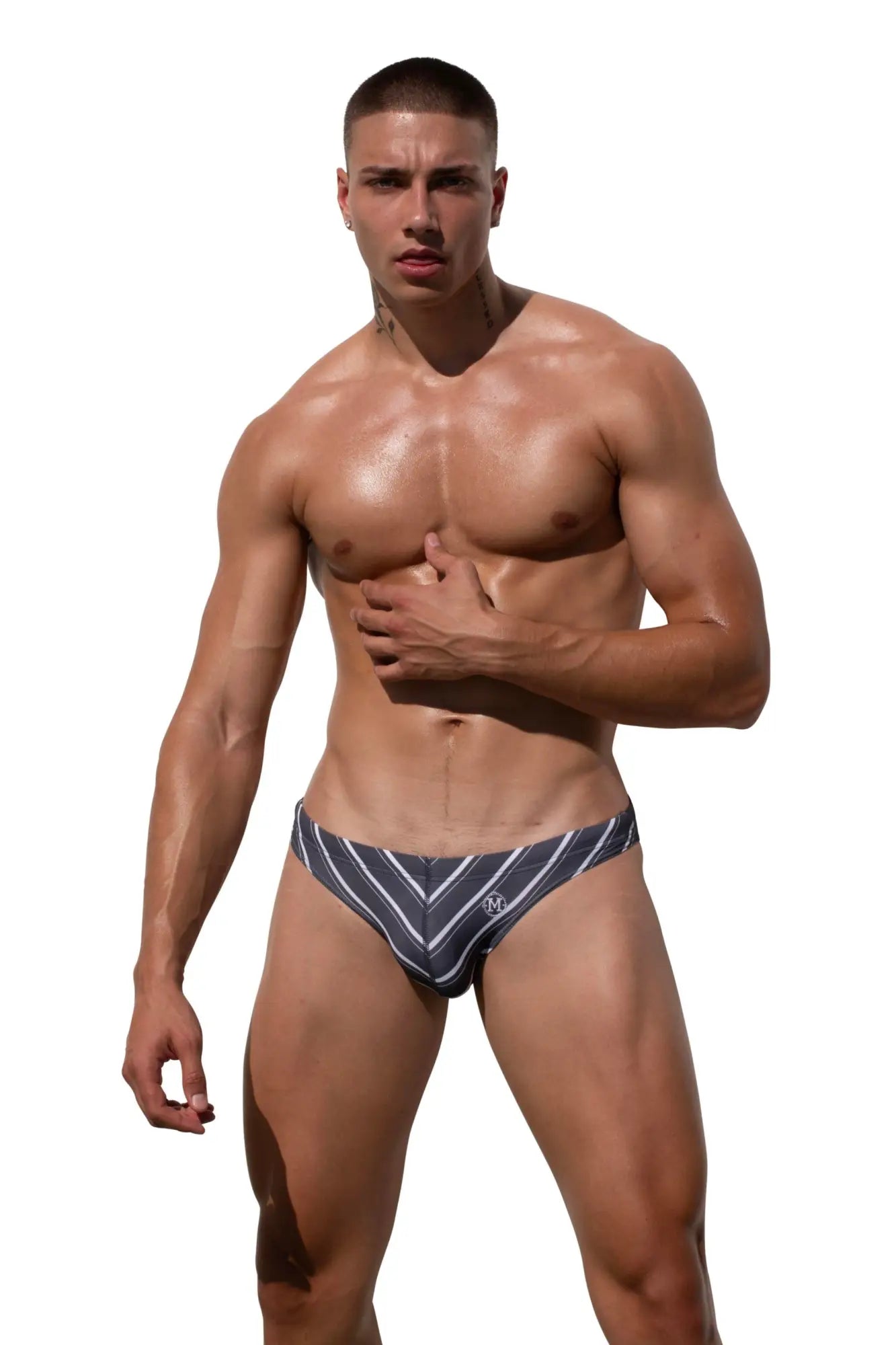 Navy blue and white striped Marcuse Vacay bikini swimwear briefs for men with a small m logo on the front