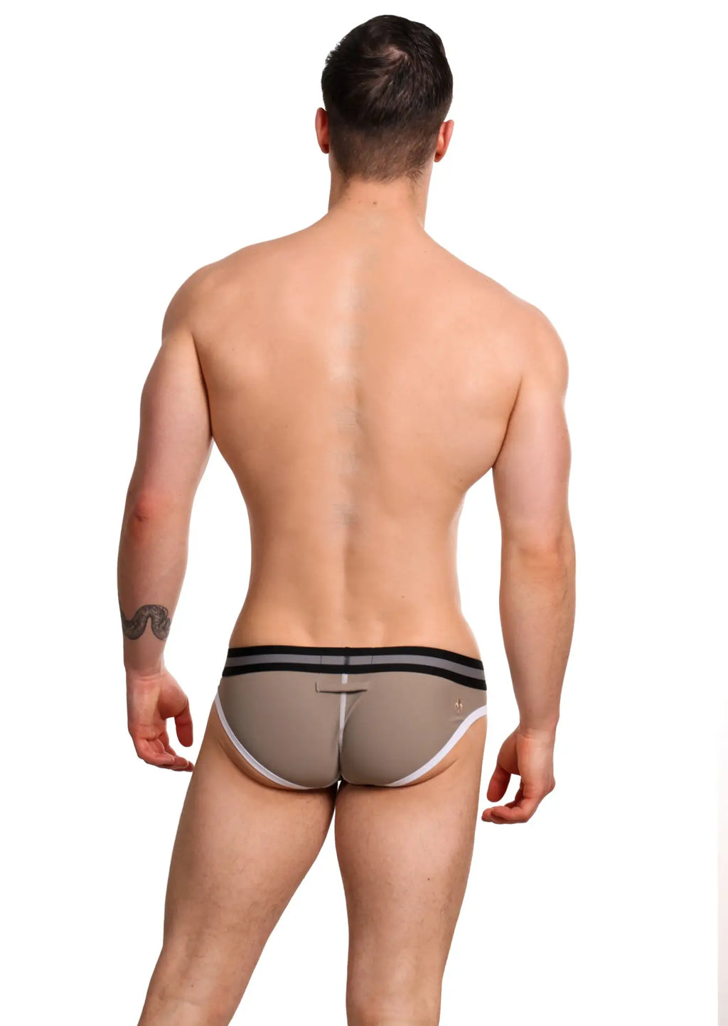 Beige marcuse vertio athletic briefs with black and white trim designed for comfortable activewear use
