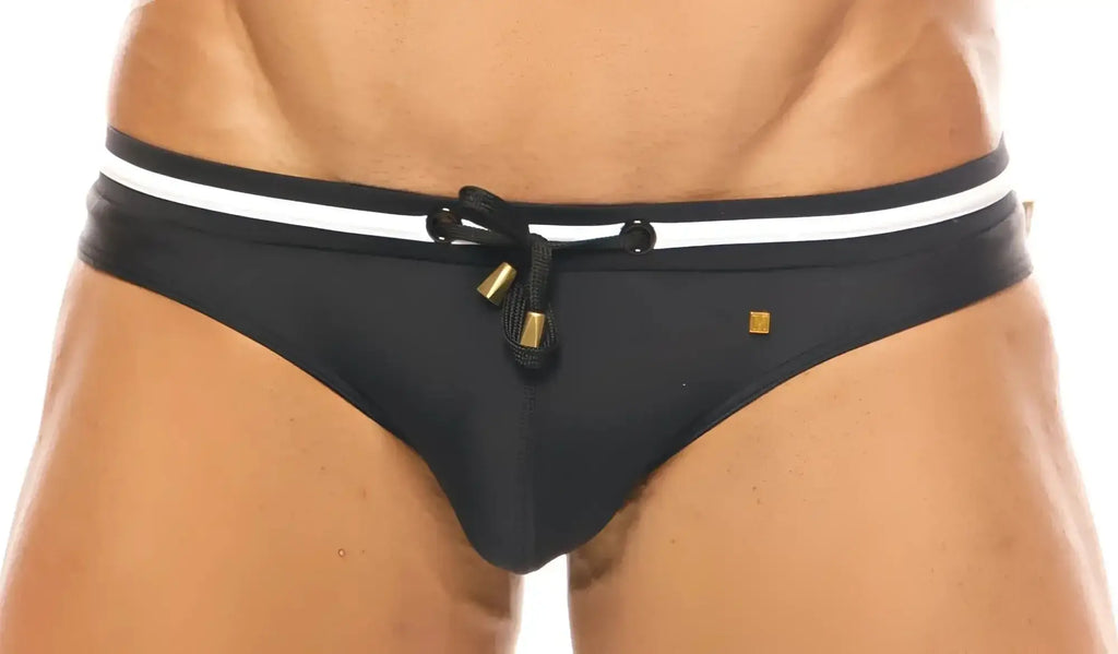 Black swim trunks with white stripes and gold-tone hardware from marcuse volie bikini swimwear collection