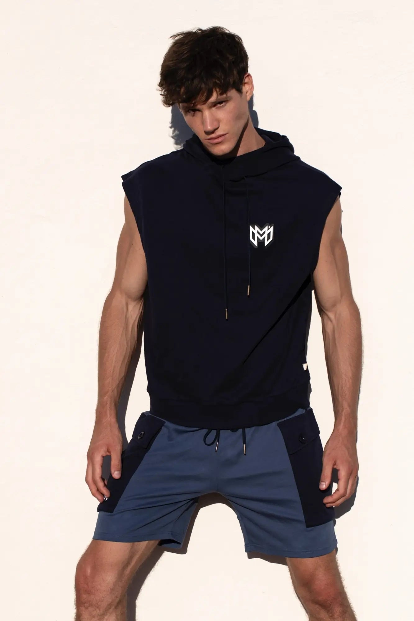 Black sleeveless Marcuse Zaiden hoodie tank top with white logo on chest made of comfortable fabric for casual wear