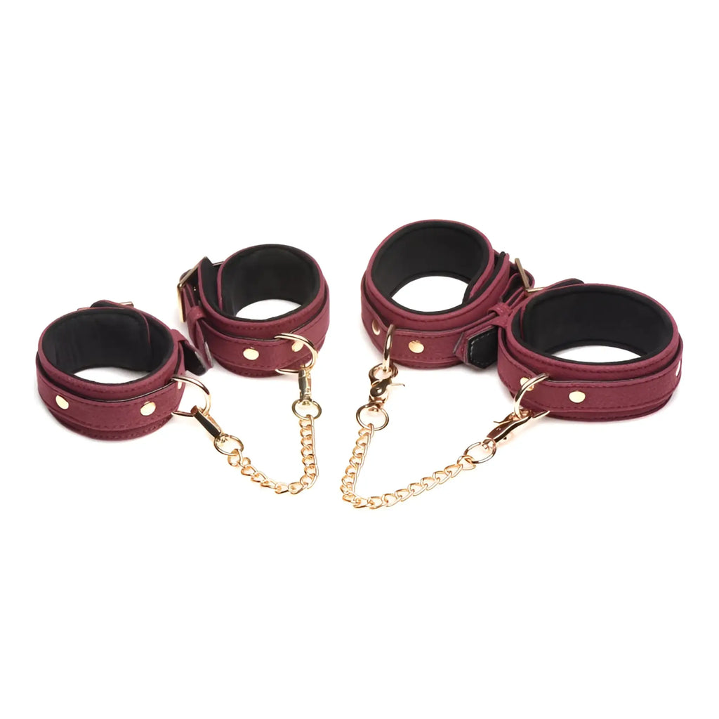 Maroon leather handcuffs with gold toned chains and silver studs from master series 6 pc velvet bondage set burgundy