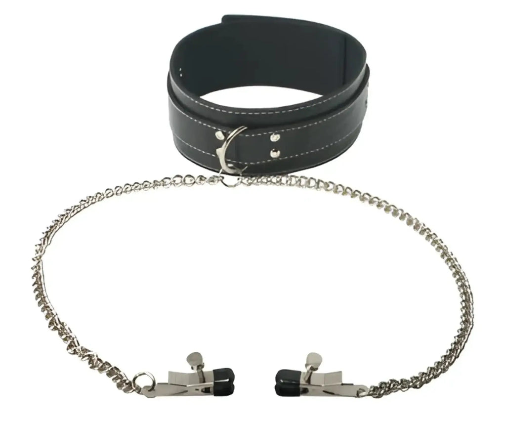 Black leather collar with silver metal clasp and chain paired with matching black tipped metal cuffs.