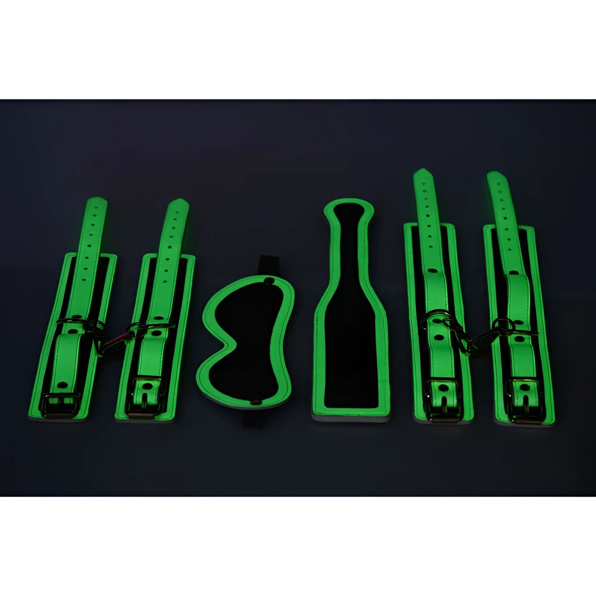 Glowing green leather bondage set with adjustable straps and metal hardware from Master Series Kink In the Dark