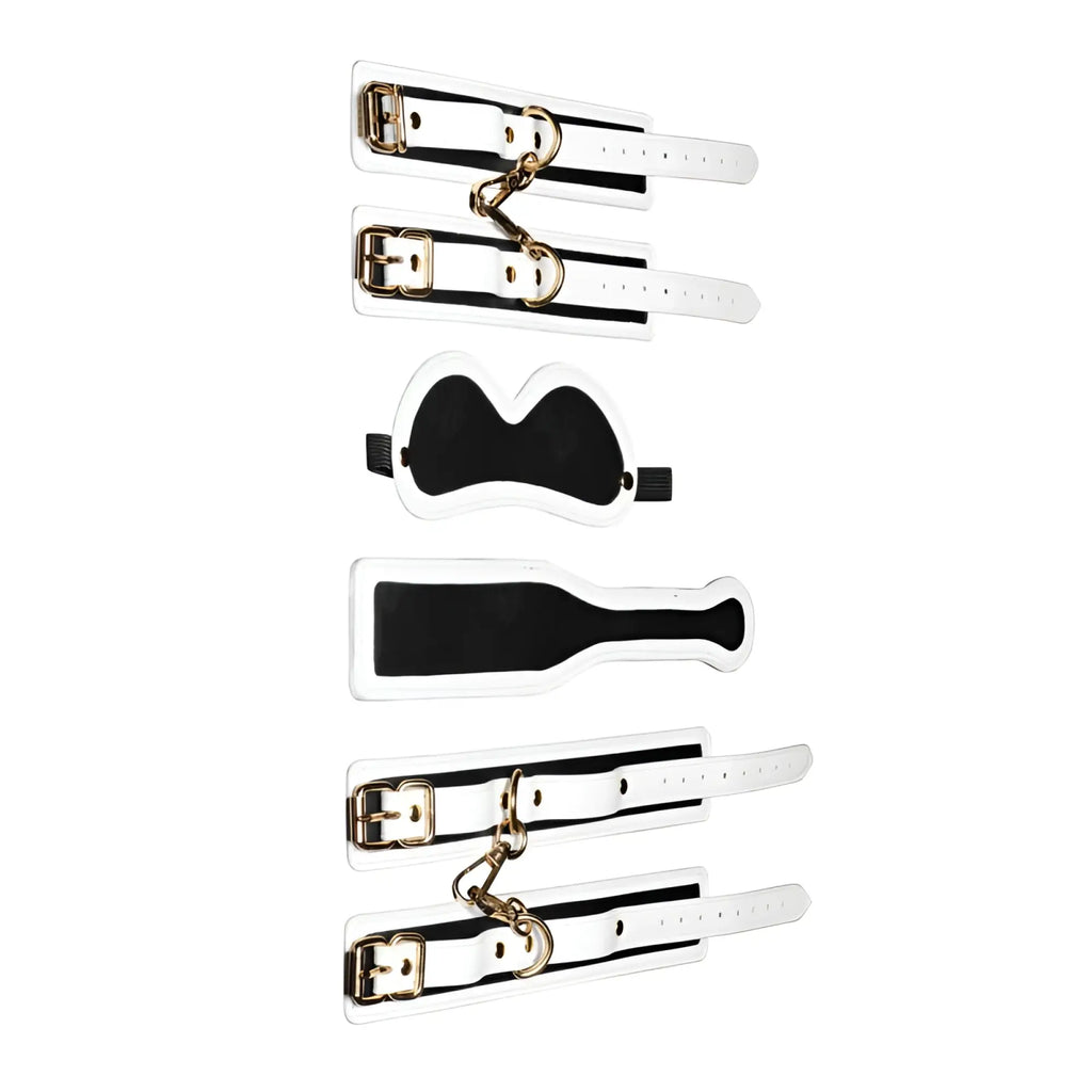 White leather bondage set with black stripes and gold-tone hardware from master series kink in the dark glowing set