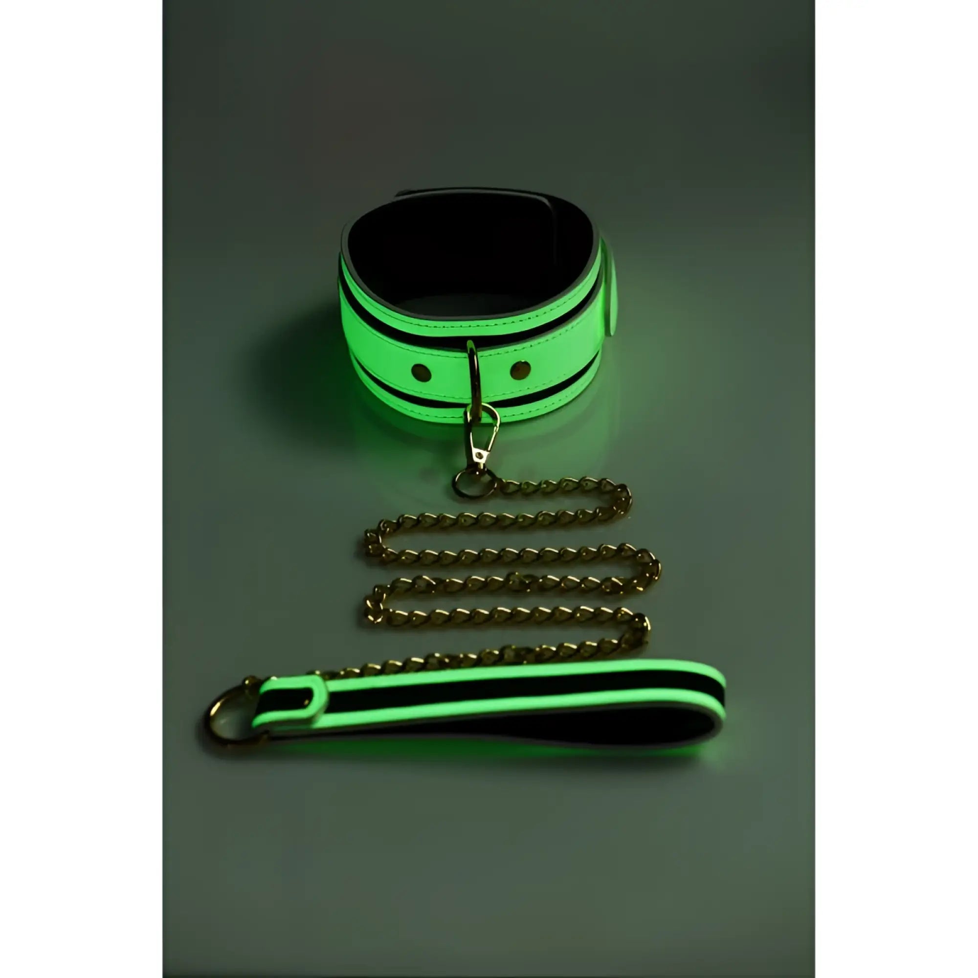 Glowing neon green and black leather collar with matching leash from Master Series Kink in the Dark collection