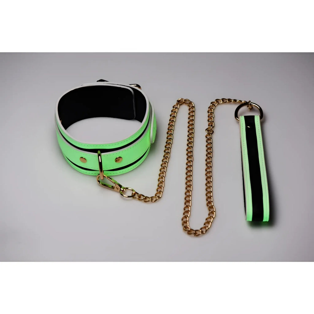 Neon green and black padded collar with gold toned chain and matching wrist strap from master series kink in the dark