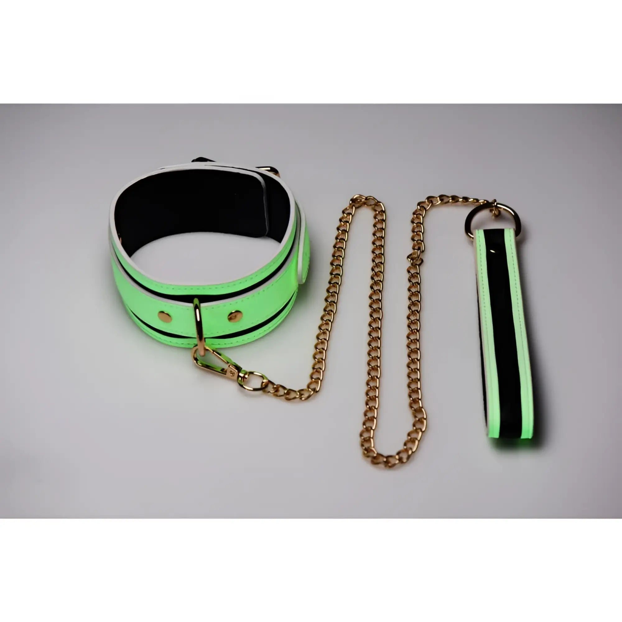 Neon green and black padded collar with gold toned chain and matching wrist strap from master series kink in the dark