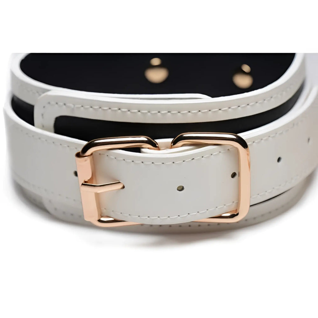 White leather belt with rose gold buckle and black lining featured in master series kink glowing collar and lead fluro green