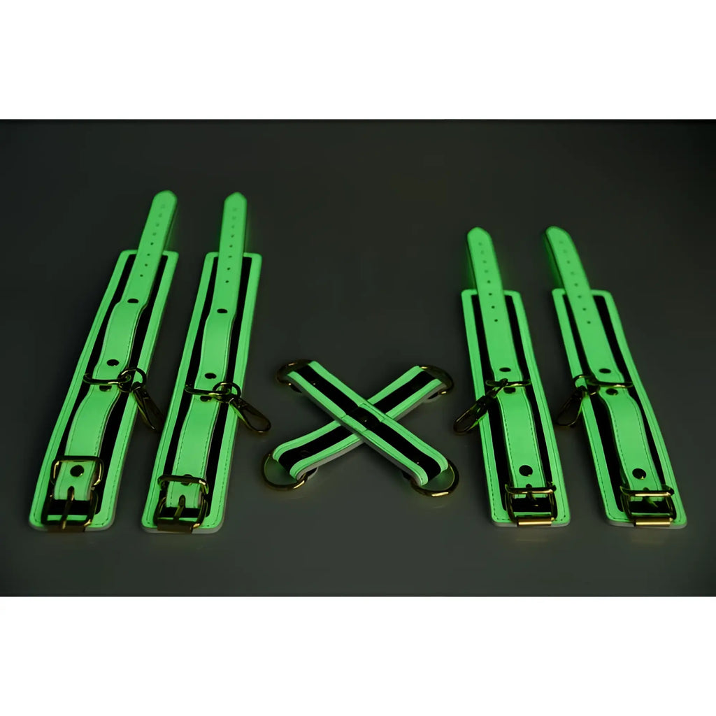 Set of four neon green glow-in-the-dark leather cuffs with black trim and gold metal hardware for hog tie use
