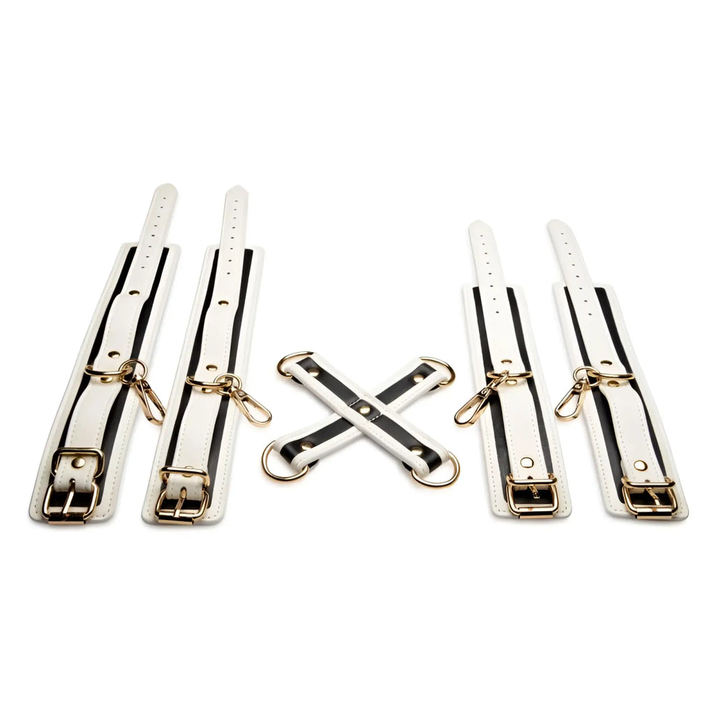 White leather bondage set with black stripes and gold tone hardware from master series kink in the dark glowing hog tie set fluro green