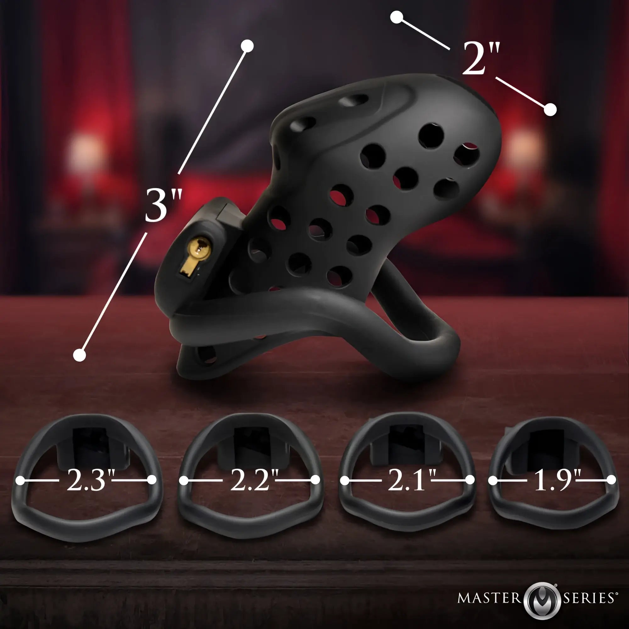 Black silicone chastity cage with gold lock and adjustable rings from the master series lock down chastity cage product