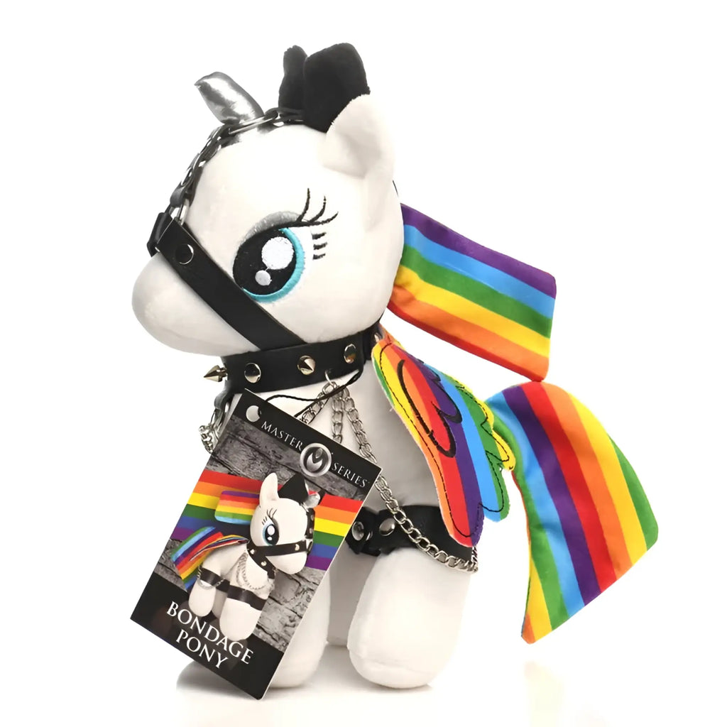 Master series prism pearl bondage pony is a white plush pony with rainbow wings, tail, and black leather harness with silver studs