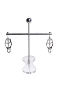 Silver metallic claw-style nipple clamps from master series the tower of pain displayed on clear acrylic stand