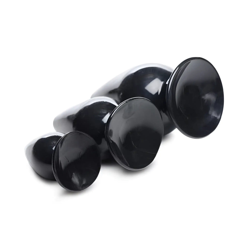 Set of black glossy silicone anal plugs with three smooth rounded sizes in the master series triple cones 3 pc set