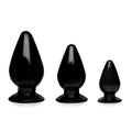 Set of three black glossy silicone anal plugs with tapered designs and suction bases from master series triple cones