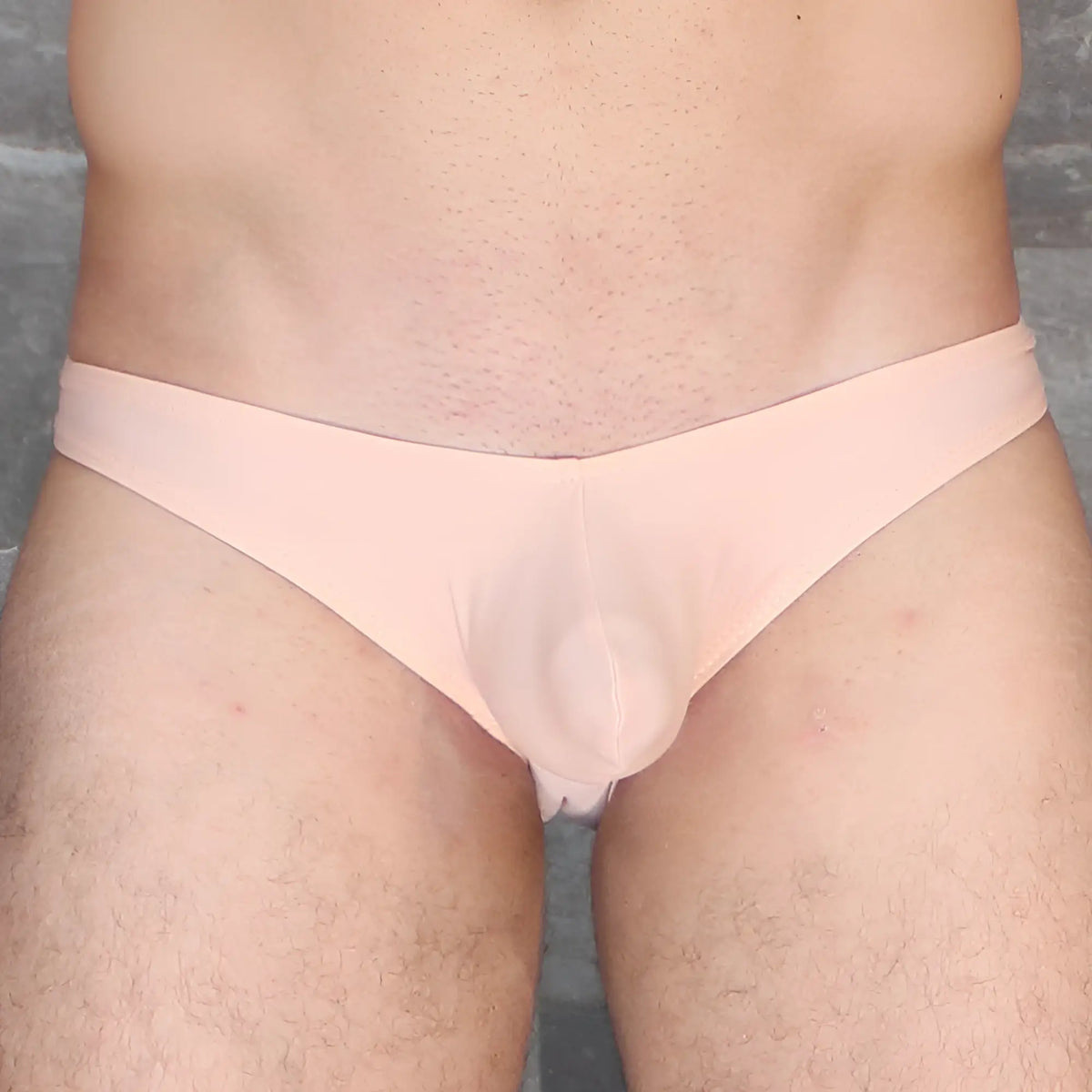 A pale pink sheer fabric thong with a smooth form-fitting design from mckillop vkds ta2 hoist bikini naked collection