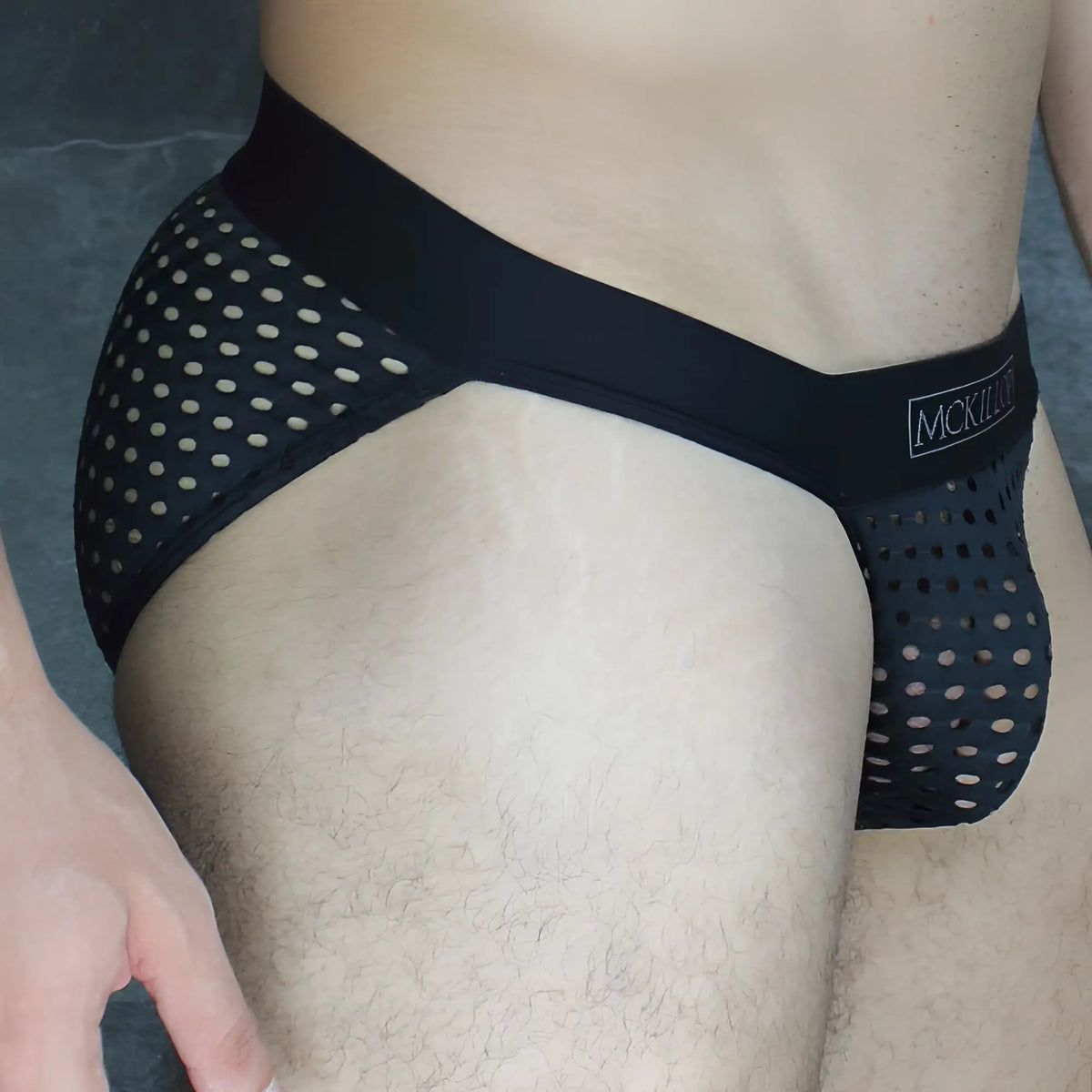 Black mesh mckillip tanga briefs with white polka dots and a solid black waistband made of glory lycra