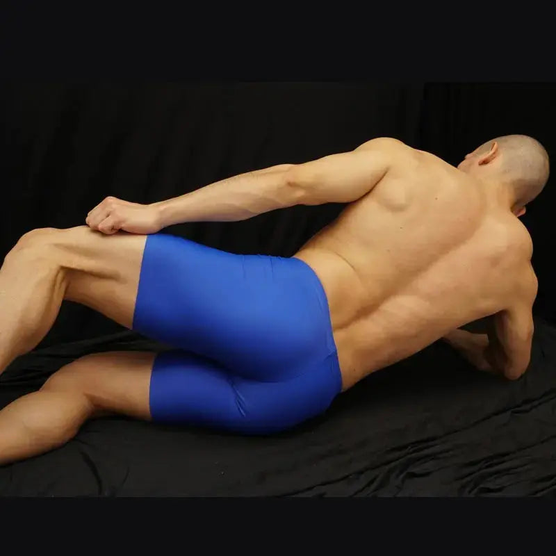 Blue athletic shorts made of stretchy material shown on a model from the side highlighting fit and comfort by Arroyman