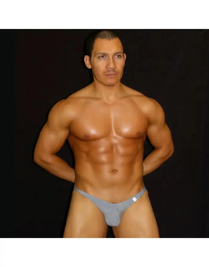Gray checkered bikini underwear by Arroyman featuring a low-rise cut and minimal coverage modeled by a man.