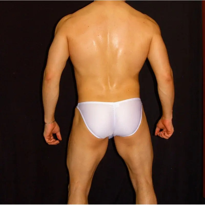 White bikini-style underwear by Arroyman featuring a snug fit and smooth fabric shown on a model from the back.